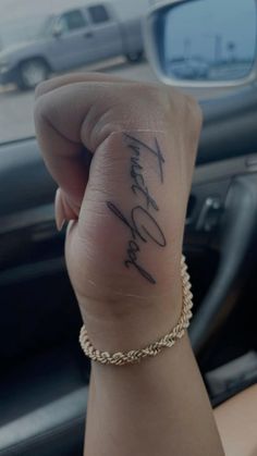 a woman's hand with a tattoo on it