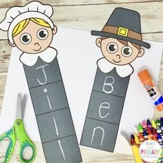 two children's bookmarks with the letters j and i on them, sitting next to crayons