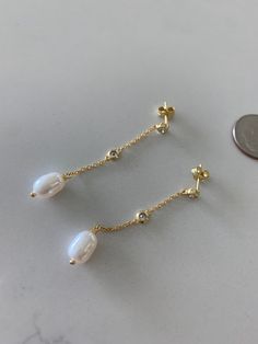 These long pearl drop earrings are the perfect bridesmaid gift. With a pear-shaped dangle cream pearl design, these glamorous earrings can be worn alone or combined with other earring styles for a wedding day look. A great gift for Valentine's Day, Mother's Day, Anniversary and Christmas.♦ Materials: Sterling Silver & Gold over Silver, Cubic Zirconia, Fresh Water Pearls ♦ Available colors: Gold, Rose Gold and Silver♦ Earrings Measurements: 3MM Cubic Zirconia, 8MM Pearl, Total Length 45MM, Pearls Dainty Teardrop Pearl Earrings For Party, Pearl Drop Earrings For Bridesmaid, Party Long Drop Pearl Teardrop Earrings, Party Pearl Drop Long Teardrop Earrings, Party Long Drop Teardrop Earrings With Pearl, Teardrop Linear Earrings With Pearl Chain For Gifts, Teardrop Pearl Chain Linear Earrings As Gift, Single Dangle Pearl Earring For Anniversary, Silver Pear-shaped Pearl Earrings For Formal Occasions