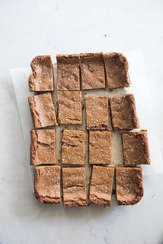 brownies cut into squares sitting on top of a cutting board