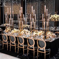 a long table is set up with chairs and centerpieces for an elegant event