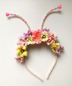 a headband with flowers and beads on it