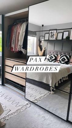 a bedroom with mirrored closet doors and bed in the corner, next to a mirror that says pax wardrobes