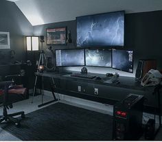 a computer desk with three monitors on top of it in front of a laptop and speakers