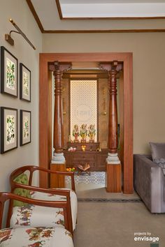 a living room filled with furniture and pictures on the wall