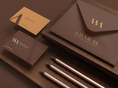 an assortment of stationery items including pens, envelopes and business cards