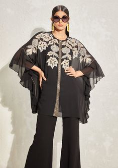 Editor's Note The black georgette floral embroidered kaftan set features a flowy kaftan with intricate floral embroidery, paired with flared pants and a matching slip. The kaftan's loose silhouette and elegant embroidery make it a perfect choice for formal occasions or evening events. Color: Black Fabric: Georgette Component: Kaftan, pant and slip Occasion: Evening wear Disclaimer: Product color may slightly vary due to photographic lighting sources or your monitor setting. Care: Dry clean only Georgette Co Ord Set, Namrata Joshipura, Kaftan Set, Cord Set, Elegant Embroidery, Trendy Fashion Tops, Boutique Dress Designs, Frill Sleeves, Stylish Dress Book