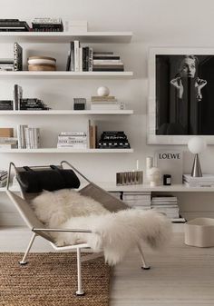 a living room filled with furniture and bookshelves