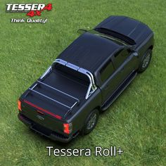 a black truck parked on top of a lush green grass covered field with the words tessena roll +