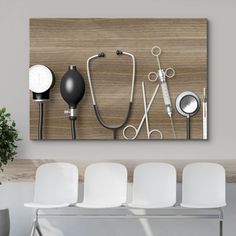 a wall mounted art piece with various medical instruments on it's side, including scissors and stethoscopes