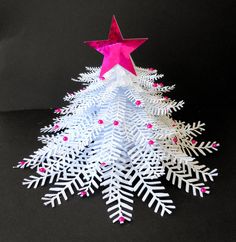 a christmas tree made out of white and pink paper