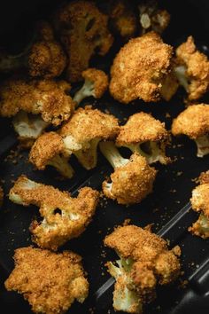 cooked broccoli florets on a black tray