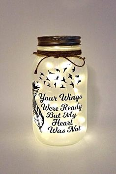 a lighted mason jar with a message on it that says, your wings were ready but my heart was not