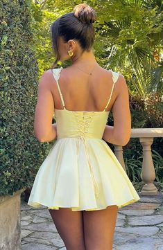 The super flirty, romantic Antonella mini dress will take you from bottomless brunch to garden parties and more. Made from a lightweight cotton blend, this mini has a super cinched waist contrasted with a full skirt, pintuck detailing to the front and lace up back. The fan shaped straps are adjustable for your perfect fit. Wear yours with lemon heels and bag. 



Colour: Lemon.

Premium nylon cotton blend fabric.

Fully lined.

Button detailing to bust.

Fan shape adjustable straps.

Tie on unde Homecoming Dresses Corset, Bottomless Brunch, Bandage Dress Bodycon, Maxi Dress Sale, Sparkle Dress, Garden Parties, Flare Mini Dress, Dresses By Length, Formal Dresses Prom