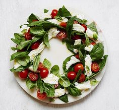 a white plate topped with spinach and tomatoes