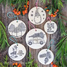 four christmas ornaments hanging on a wooden table