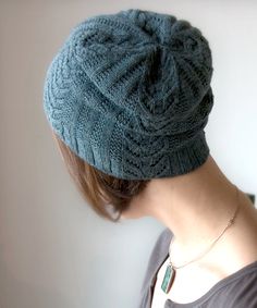 a woman wearing a blue knitted hat