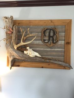 the antler is hanging on the wall next to the initials