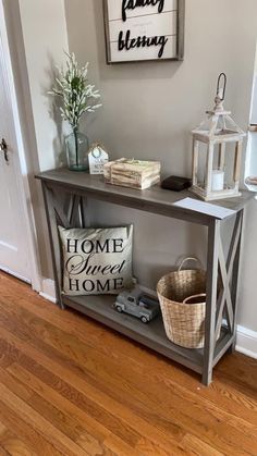 a shelf with some items on top of it in front of a door and a sign that says home sweet home