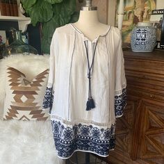 Super Cute White Linen With Blue Embroidery Detail. Has One Barely Visible Spot On The Bottom. Very Comfortable. Fits Loosely Blue Bohemian Top With Embroidered Border, Bohemian Blue Button-up Top, Blue Bohemian Free-size Tunic, Blue Bohemian V-neck Blouse, Light Blue Bohemian V-neck Blouse, Comfortable Fits, Bohemian Top, Bohemian Tops, Blue Embroidery