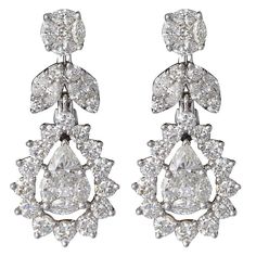 An elegant earring that shines alone or will compliment other pieces of jewelry in your own collection. 2.84 carats of F-G color VS clarity diamonds set in 18k white gold. The earring is made up of special cut diamonds that create the illusion pear shape, marquise and round top of the earring. Approximately 1 inch in length. 0.45 inches at the widest point. A wonderful gift. Art Deco Drop Earrings, Earrings Multiple, Bridal Jewels, Round Diamond Earrings, Vintage Drop Earrings, Diamond Earrings Studs Round, Jewellery Diamond, Rose Fashion, Earrings Round