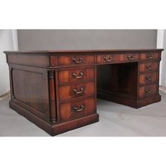 an antique wooden desk with two drawers