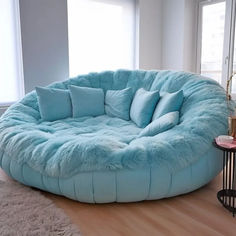 a large round bed in the middle of a living room