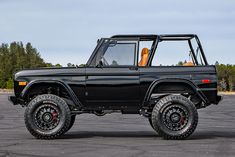 an off road vehicle parked in a parking lot