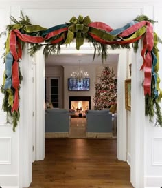 a living room filled with furniture and christmas decorations