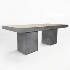 a concrete table sitting on top of a white floor