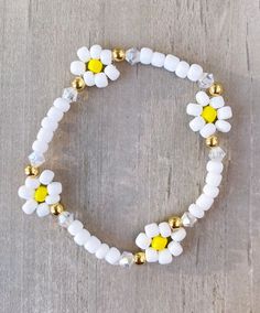 The White Flower Bracelet  Made with 4mm seed beads, bicone beads and 18k gold filled beads Bracelet comes as shown, if you would like another color please add in Personalization Section CARING TIPS FOR YOUR JEWELRY ⭐️Treat and store with care. ⭐️ For longevity, avoid exposing your jewelry to water. ⭐️ Avoid having direct contact with lotions, perfumes, sanitizers as these chemicals may cause discoloration of your jewelry. White Flower Spacer Beads, White Friendship Bracelets With Faceted Round Beads, Adjustable White Stretch Bracelet With Flower Shape, Adjustable White Flower Stretch Bracelet, White Beaded Flower Bracelets, White Beaded Flower-shaped Bracelet, White Flower-shaped Beaded Bracelets, Handmade White Stretch Bracelet With Flower Design, Handmade White Stretch Bracelet In Flower Shape