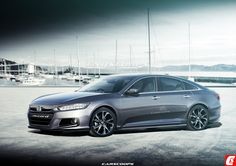 a grey car parked in front of some boats