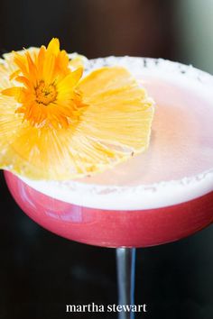 a close up of a drink with a flower on the rim