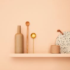 a shelf with vases and other decorative items on it, along with a candle holder