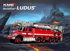 a red fire truck parked in front of a mountain with flames coming out of it