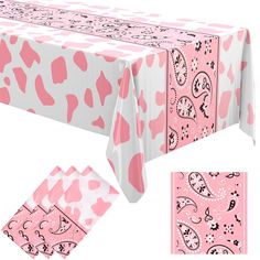 the table cloth has hearts on it and is pink with black dots, which are scattered around