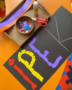 a child's art project with construction paper and scissors