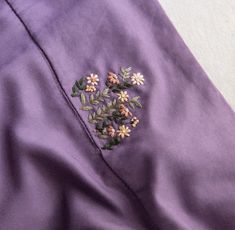 a purple jacket with flowers embroidered on it