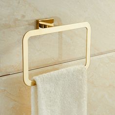 a towel rack with two towels hanging from it's sides and a towel on the other side