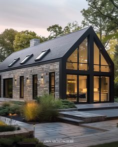 a modern house with black shingles and windows