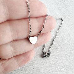 Dainty heart necklace is lightweight and perfect for everyday wear! A tiny, chunky stainless steel heart charm hangs from a fine (1.5mm) stainless steel chain, which fastens with lobster clasp. Necklace is available in 3 lengths. Stainless steel will not tarnish, and is a great alternative for those with a sensitivity to metal! All items are carefully wrapped, packaged, and presentable for gift giving. In order to remain environmentally friendly, I only include a box when requested. A gift messa Dainty Heart Necklace, Tiny Heart Necklace, Flamingo Earrings, Wife Necklace, 18th Birthday Gifts, 16th Birthday Gifts, Clasp Necklace, Wear Necklaces, Everyday Necklace