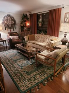 a living room with couches, chairs and rugs in front of a window