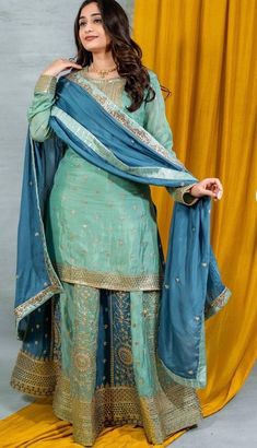 Readymade chinos sage green and blue heavy embroidered Sharara Suit, Punjabi Salwar suit. It is available for fast delivery. Indian Pakistani wedding dress Details Sharara/Salwar/Plazzo Fabric: Chinon Colour : Sage green and blur Inner: Crape lined Design: Huge flair with heavy embroidery on the Sharara Kameez/Shirt/Kurti Fabric: Chinon Colour: Sage green Inner : Crape lined Design:Heavy embroidery on neck and hem of the shirt Dupatta Fabric : Georgette Color: Sage green Design :Beautiful dupatt Punjabi Wedding Outfits, Pakistani Sharara Suit, Sage Green And Blue, Shirt Kurti, Made Costume, Suit Punjabi, Suit Indian, Embroidered Sharara, Punjabi Salwar