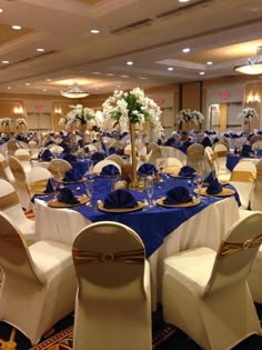 a banquet room set up with blue and white linens