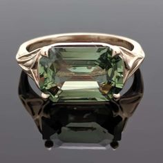 14kt Yellow Gold Green Sapphire Ring. This ring features a large emerald-cut green sapphire in 4 prongs with delicate twisted gold shoulders. This item is a custom order only. Price is for the ring setting only. The stone will be priced separately. The completion of the item will take about 10 - 20 days. You can use your own center stone or request a quote for stones from our inventory. Please provide the ring size or we will make it an average size 7. Green Emerald-cut Sapphire Ring With Bezel Setting, Green Sapphire Ring With Emerald Cut Bezel Setting, Formal Green Emerald-cut Sapphire Ring, Individual Aesthetic, Multi Gem Ring, Non Traditional Wedding Ring, Star Sapphire Ring, Saphir Ring, Green Sapphire Ring