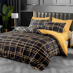 a black and yellow comforter set on a bed