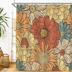 a shower curtain with an image of flowers on it in front of a potted plant