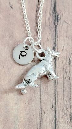 "This listing is for a hand-stamped initial necklace featuring a 1/2\" x 3/4\" silver plated pewter German Shepherd charm & 2/5\" stainless steel initial pendant. The silver plated chain is 18\" long, but can be made to your desired length- see last photo in listing for length guide. Please indicate the chain length you would like in the 'notes to seller' section at checkout. All items are lead & nickel free. Message me with any questions, thank you! Add an initial to any necklace https: Silver Hypoallergenic Initial Pendant Jewelry, Hypoallergenic Sterling Silver Dog Tag Jewelry, Silver Hypoallergenic Dog Tag Jewelry, Personalized Symbolic Silver Charm Necklace, Hypoallergenic Silver Dog Tag Jewelry, Hand Stamped Silver Pendant Jewelry, Silver Dog Tag Jewelry With Charms, Symbolic Silver Necklace For Personalized Gift, Nickel-free Silver Initial Pendant Jewelry