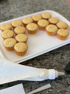 some cupcakes are on a tray next to a spatula