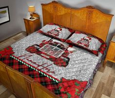 a bed with red and black plaid bedspread on it